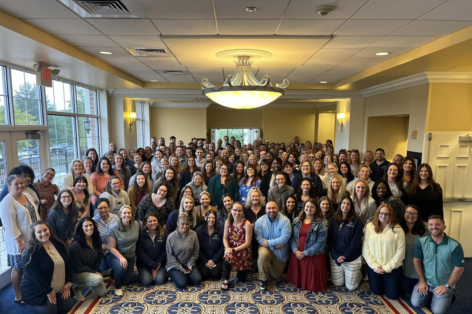 A large group of Insight PA staff and teachers gathers for a photo.