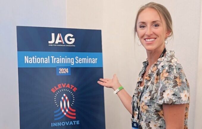 An Insight PA Staff member posing in front on the JAG National Training Seminar of 2024.