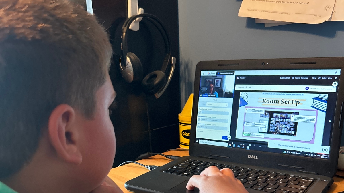 An Insight PA student is participating in a synchronous learning session from their home learning space